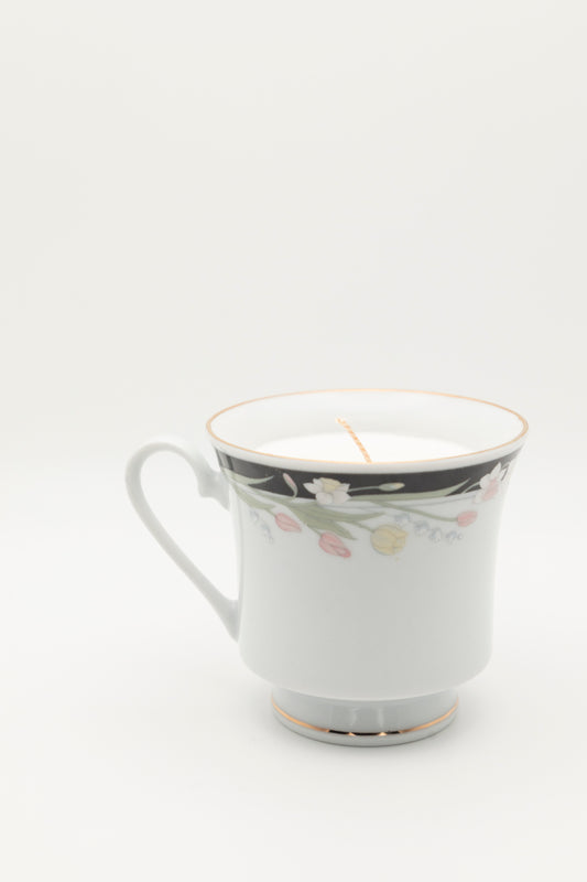 black, pink, and white floral design teacup