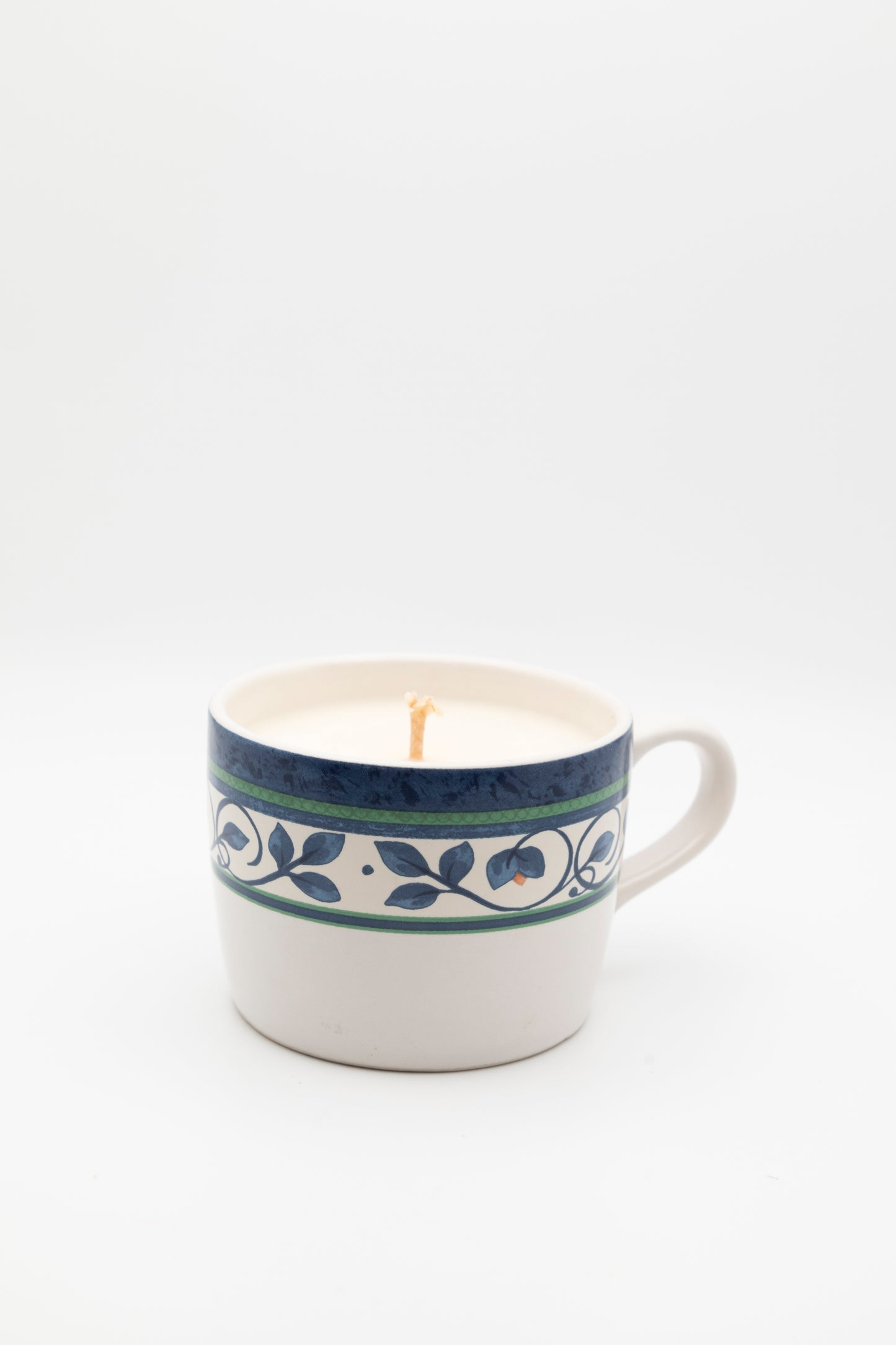 blue and green floral designed teacup