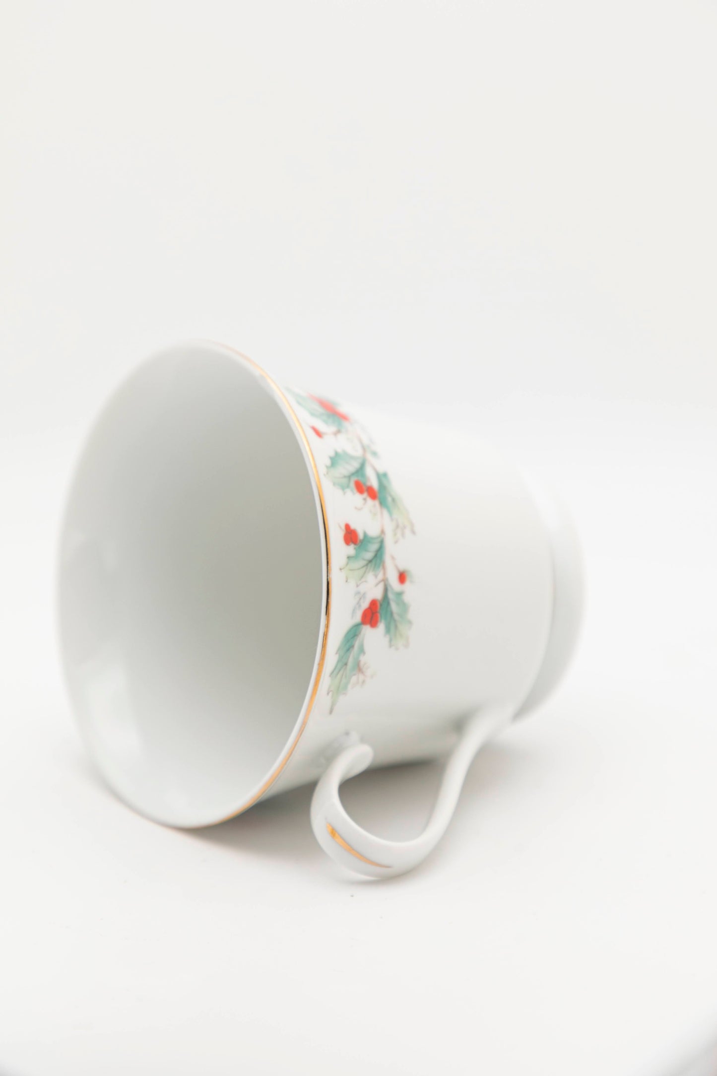 white mug with mistletoe design