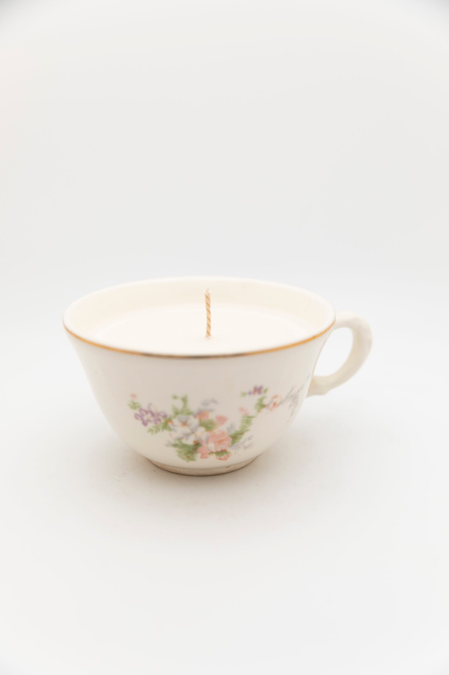 green and pink floral designed teacup