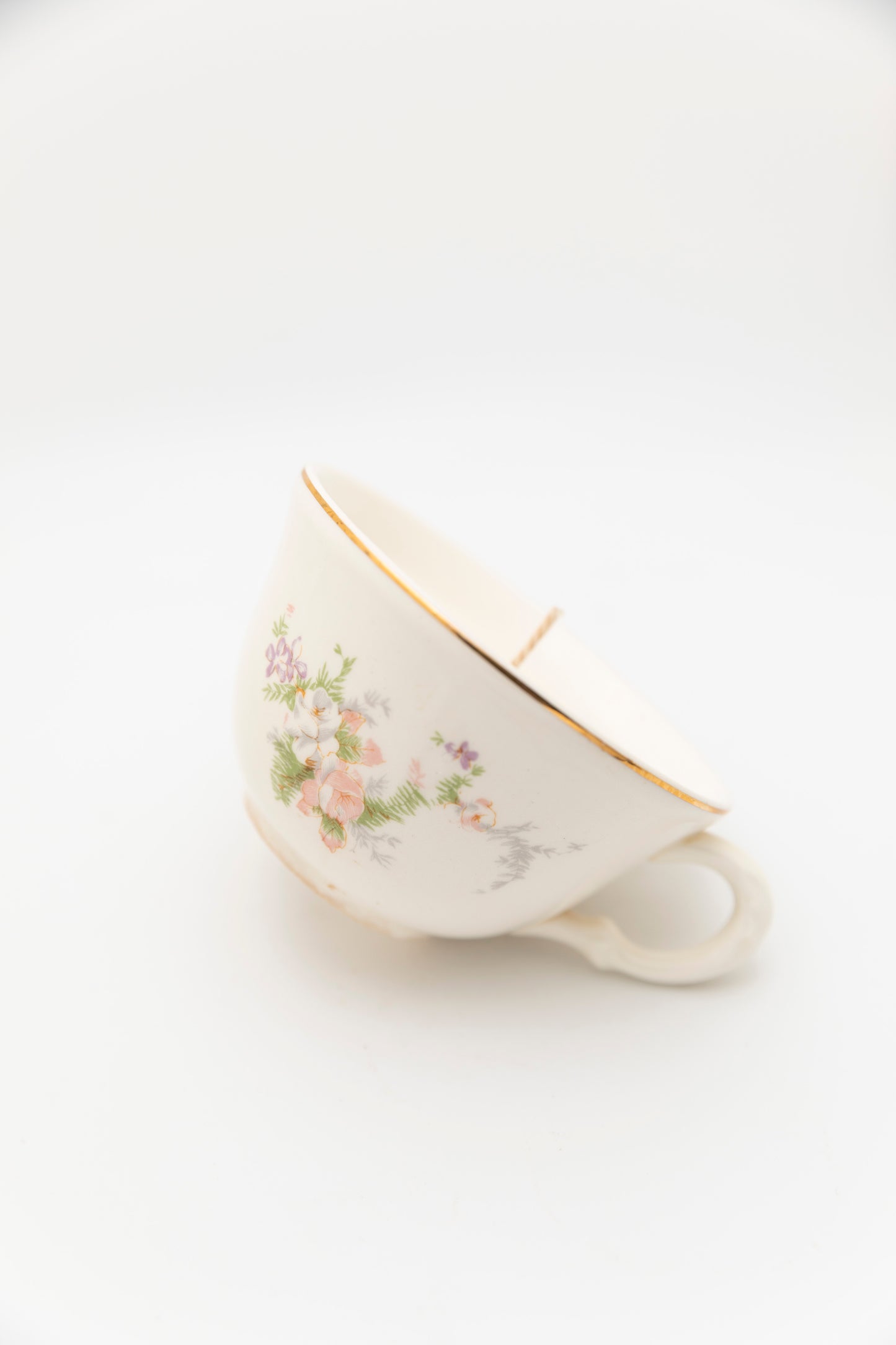 green and pink floral designed teacup