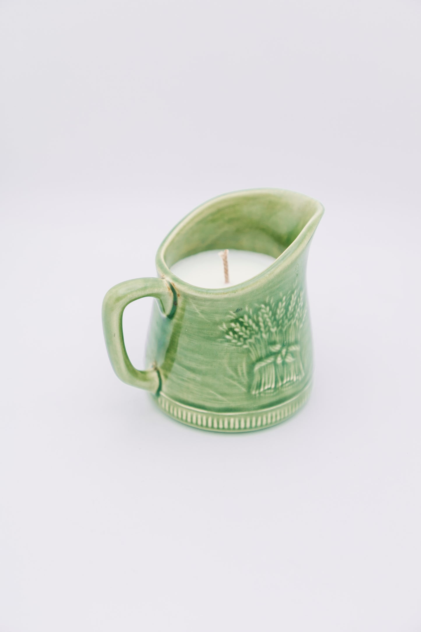 green ceramic creamer with floral design