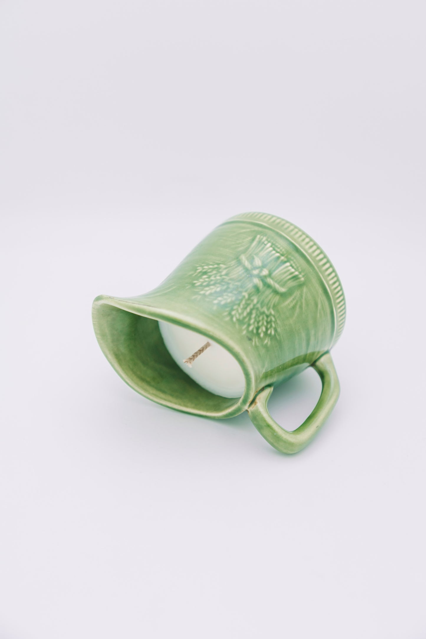 green ceramic creamer with floral design